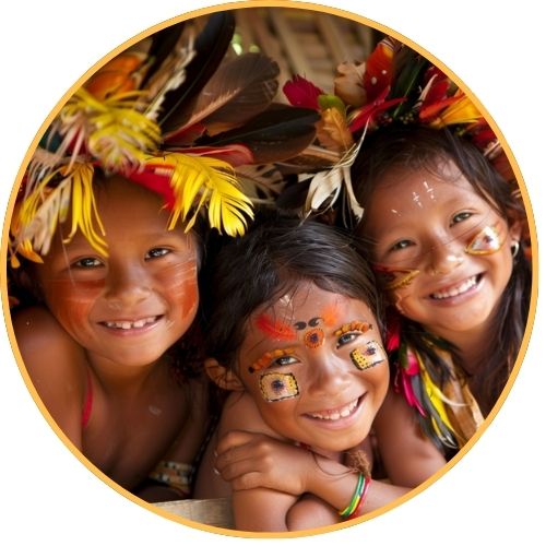 Three smiling Indigenous children with face paint and feather headdresses