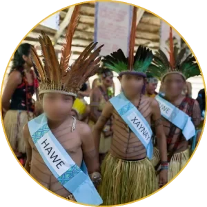 Puyanawa children with feather headdresses and sashes at a cultural celebration
