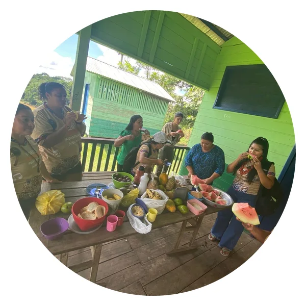 Nukini teachers share fruit during a meeting at their school