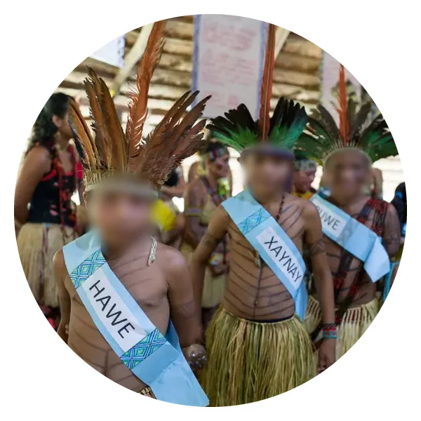 Puyanawa children with feather headdresses and sashes bearing their names