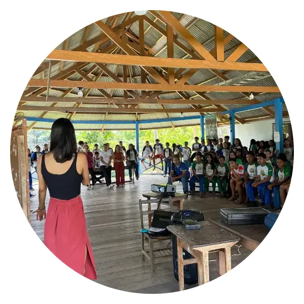 Environmental workshop with young Puyanawa people in a large covered wooden space